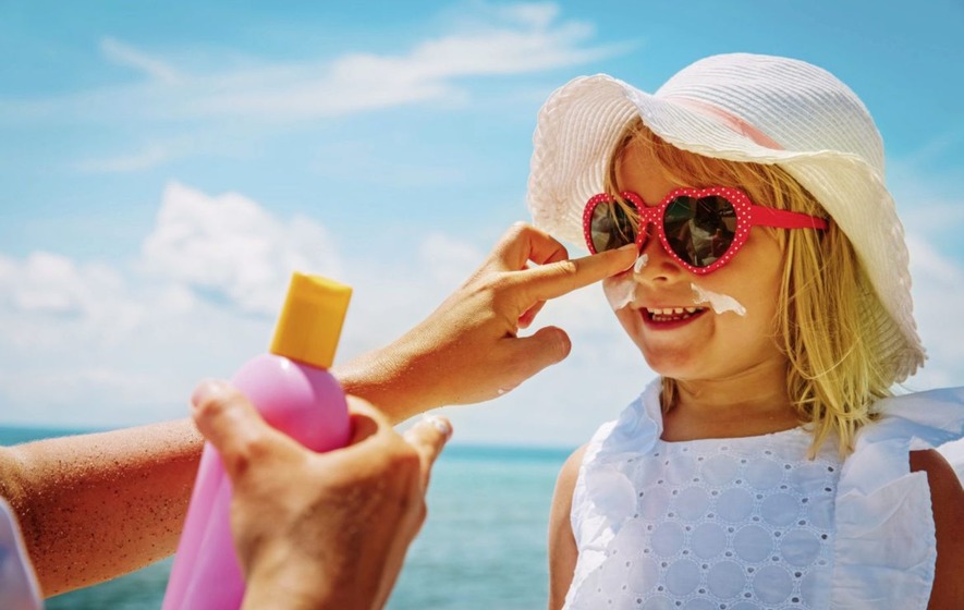 Applying Sunscreen to a little girls face